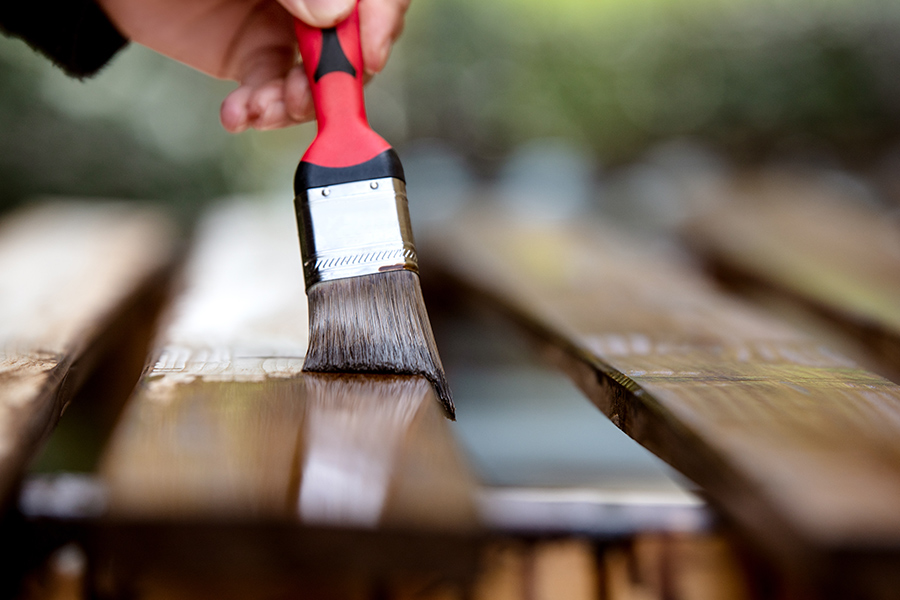 contractor deck painting with brush